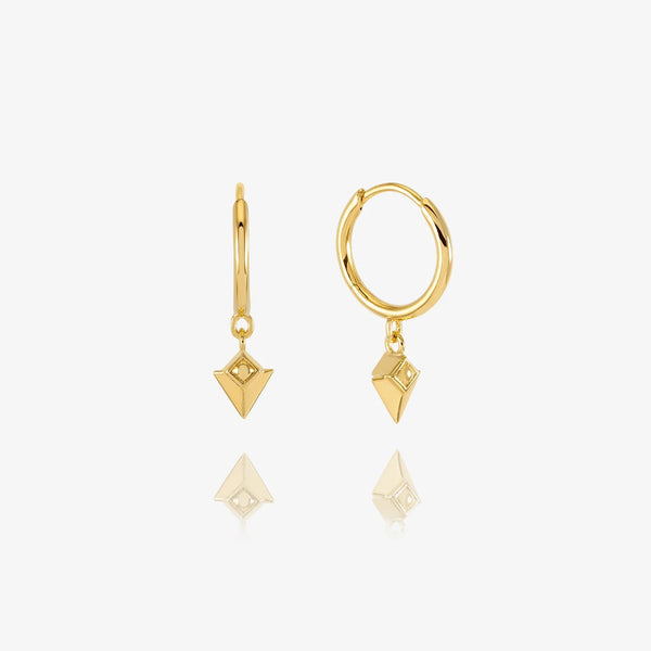 Gold huggie earrings with arrow spike charm on white background