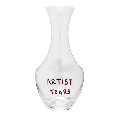 Clear glass decanter with 'ARTIST TEARS' text on a white background