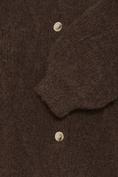 Close-up of a brown of mohair cardigan fabric with buttons