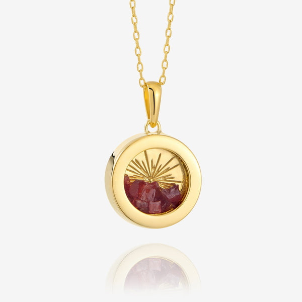 Gold art deco amulet necklace on white background