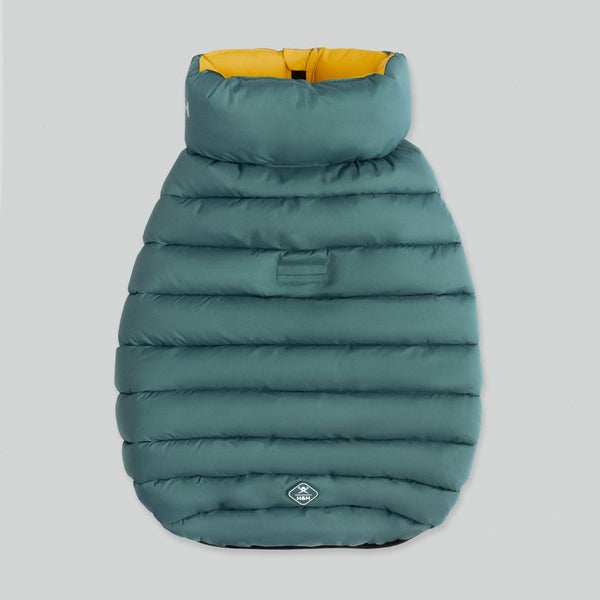 Green puffer jacket for a dog with no sleeves and yellow lining on light grey background