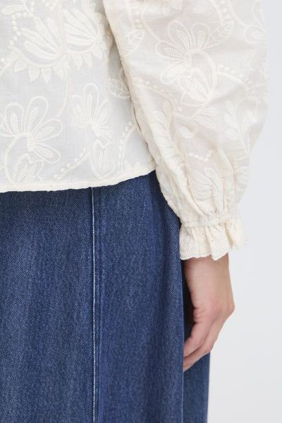 White embroidered blouse with long sleeves with gathering around writst