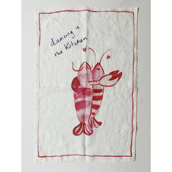 Tea towel with red lobster design and text 'dancing in the kitchen' on a white background