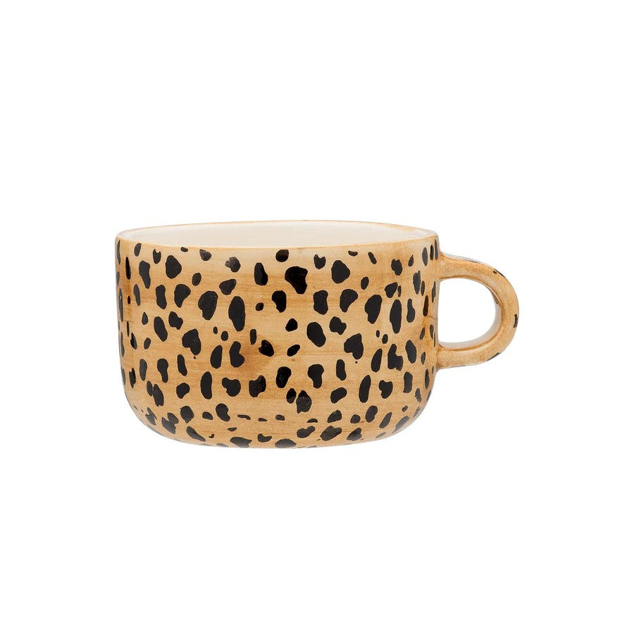 Ceramic mug with leopard print design on a white background