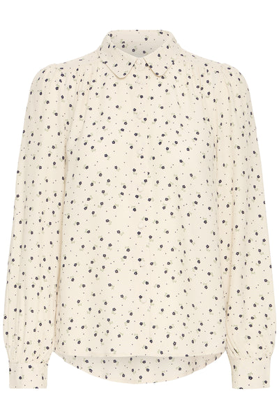 Cream blouse with black floral pattern on a white background