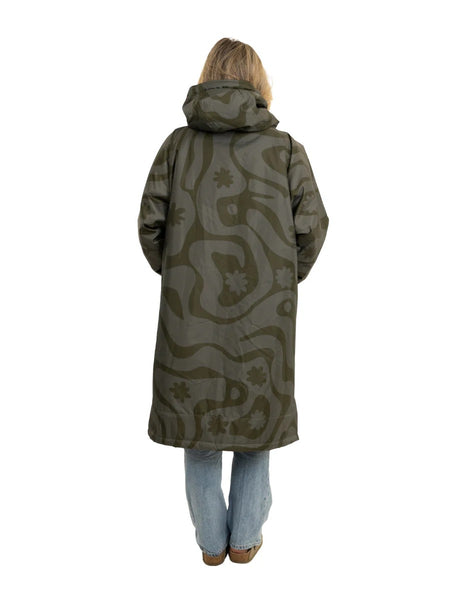 Person standing in a green olive changing robe showing the back of the coat with a hood on a white background. 