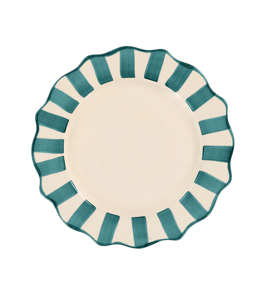 Ceramic plate with scalloped edges with green stipes around the edge on white background