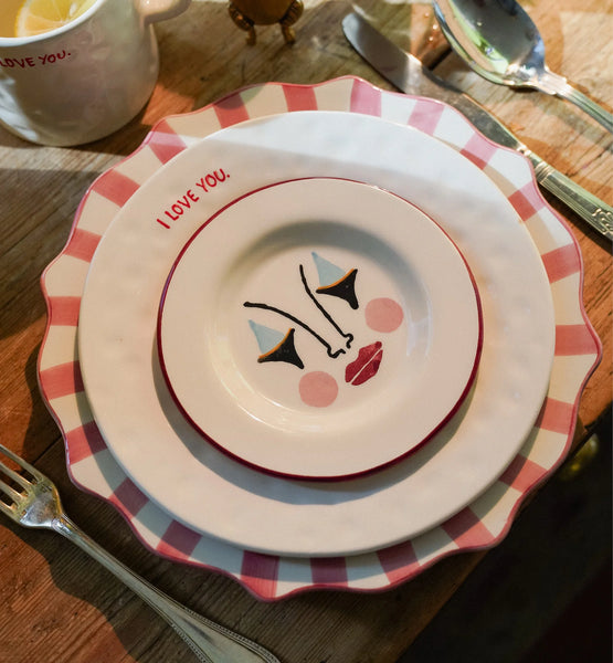 Three plates on top of each other on a set table 
