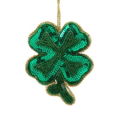 Green sequin four-leaf clover ornament with gold trim on a white background