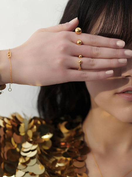 Person with Gold stellar orb adjustable ring on fingers