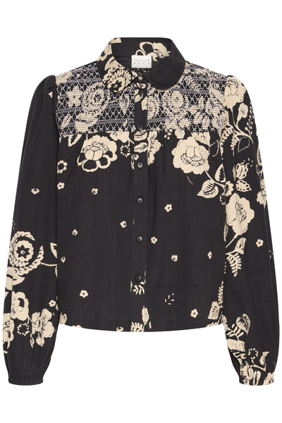 Black blouse with white floral and geometric patterns on a white background