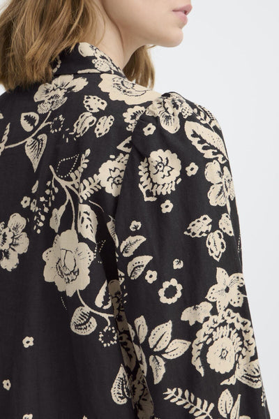 Black floral patterned blouse showing shoulder details