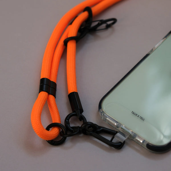 Adjustable orange phone lanyard strap designed for comfortable crossbody wear and convenient smartphone access.