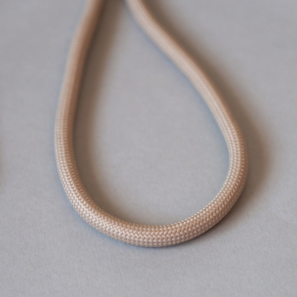 Natural beige adjustable rope phone lanyard with crossbody design for convenient hands-free everyday use.