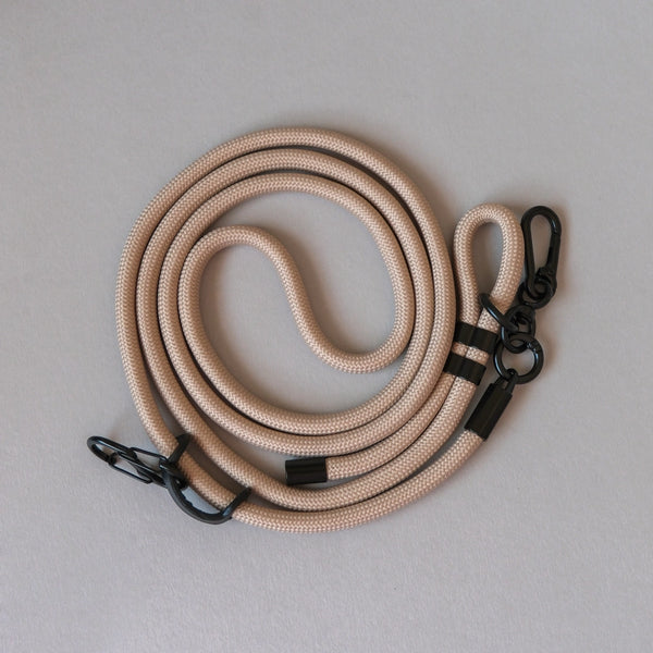 Natural beige crossbody rope phone strap keeping your smartphone secure and accessible while travelling, shopping, or commuting.