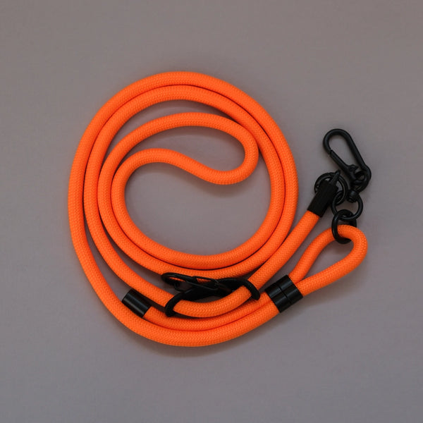 Orange crossbody phone strap keeping your smartphone secure and accessible while travelling, shopping, or commuting.