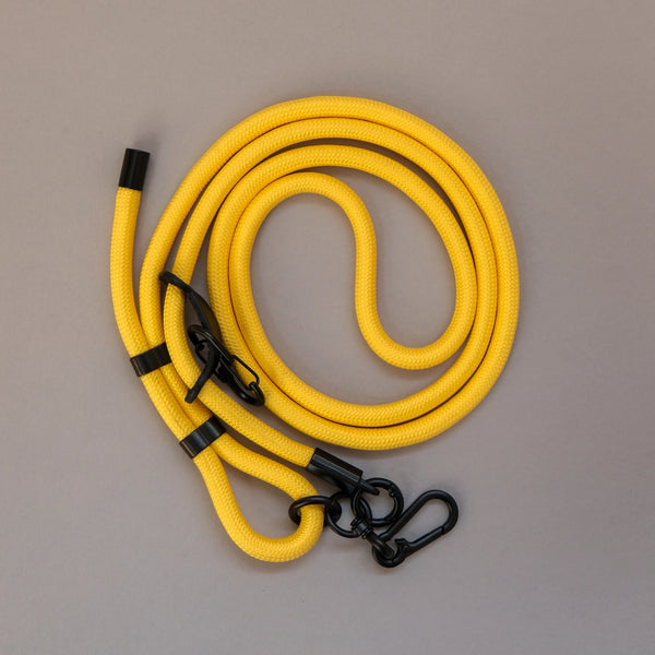 Yellow crossbody phone strap keeping your smartphone secure and accessible while travelling, shopping, or commuting.